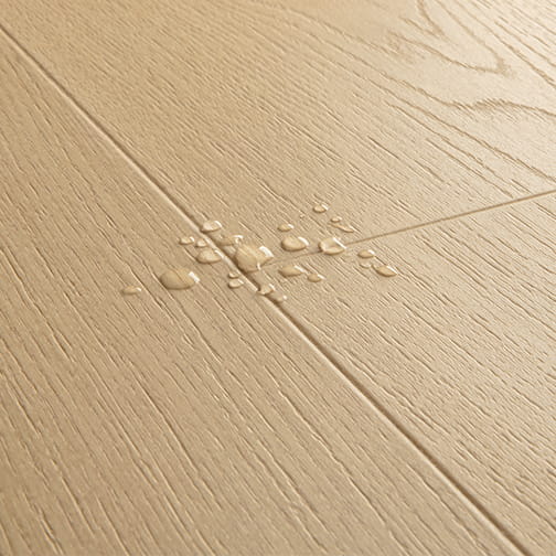 close up of beige laminate floor with water drops